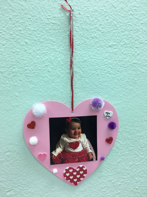 A pink tactile valentine with a picture of a baby